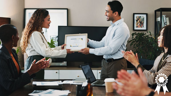 Award ceremony in office with people clapping. Award ceremony in office with people clapping.