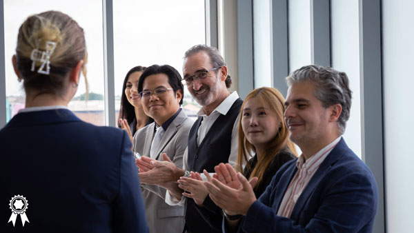 Colleagues clapping for award recipient. Colleagues clapping for award recipient.