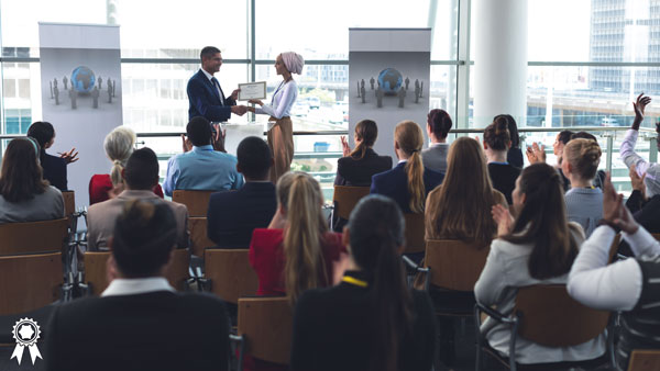 Woman receiving award in at a conference. Woman receiving award in at a conference.