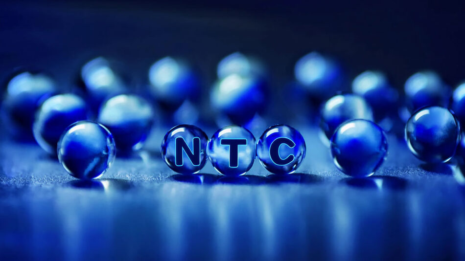 Three Marbles with “NTC” written on them with marbles in the background. Three Marbles with "NTC" written on them with marbles in the background.