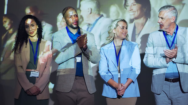 Business people standing on stage after being nominated for an award. Business people standing on stage after being nominated for an award.